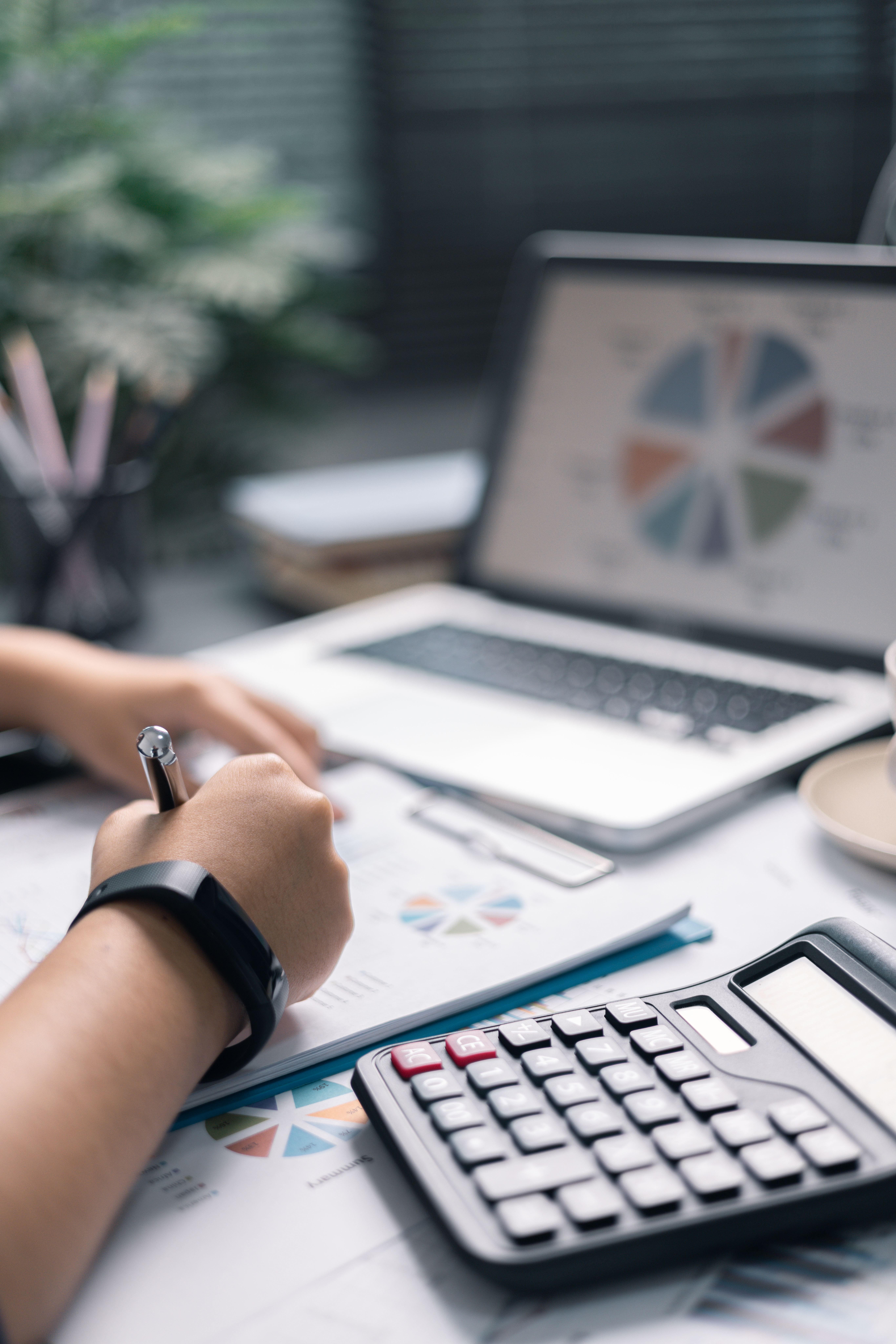 Finance bank tax expense accounting budget money businessman hand use Financial calculate accountant close up calculator with graph chart write office desk Business expense analysis saving home car